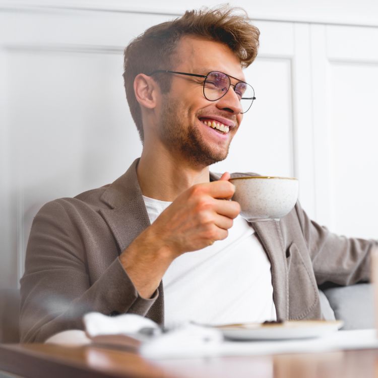 A happy man drinking a cup of coffee